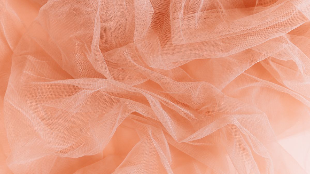 Folds of soft peach tulle fabric.