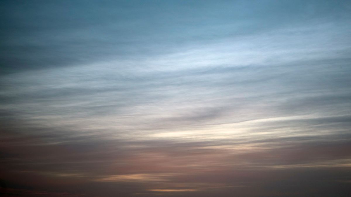 A dusk sky in blue, grey and pink.
